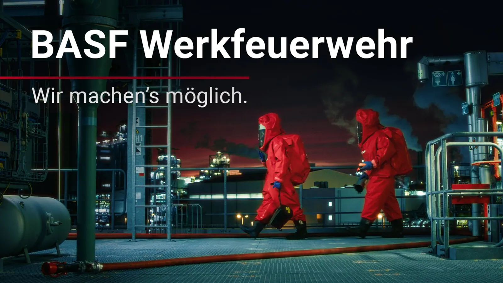 Einsatzkräfte in roten Schutzanzügen nachts in einer Industrieanlage, Titel „BASF Werkfeuerwehr“